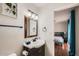 Well-lit bathroom with a decorative mirror and a door to the bedroom at 15841 N 23Rd Pl, Phoenix, AZ 85022