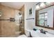 Clean bathroom featuring tiled shower, decorative accents, and modern fixtures at 15841 N 23Rd Pl, Phoenix, AZ 85022