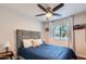 Bright bedroom with a window, ceiling fan, and comfortable furnishings at 15841 N 23Rd Pl, Phoenix, AZ 85022