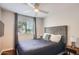 Bedroom featuring a large window, ceiling fan, and modern decor at 15841 N 23Rd Pl, Phoenix, AZ 85022