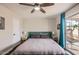 Comfortable bedroom with hardwood floors, stylish lamps, and a sliding glass door at 15841 N 23Rd Pl, Phoenix, AZ 85022