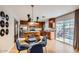 Charming dining area connected to a modern kitchen with access to an outdoor pool area at 15841 N 23Rd Pl, Phoenix, AZ 85022