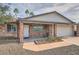 Inviting brick home with a covered front porch and desert landscaping, perfect for relaxing at 15841 N 23Rd Pl, Phoenix, AZ 85022