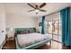 Serene main bedroom with a large window, hardwood floors, and modern ceiling fan at 15841 N 23Rd Pl, Phoenix, AZ 85022