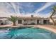Backyard pool with a diving board, palm tree, covered patio, and plenty of space for outdoor recreation at 15841 N 23Rd Pl, Phoenix, AZ 85022