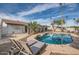 The backyard features a private pool, lounge chairs, and a covered patio with a well-maintained lawn at 15841 N 23Rd Pl, Phoenix, AZ 85022