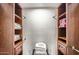Functional walk-in closet with built-in wooden shelving and storage solutions at 15841 N 23Rd Pl, Phoenix, AZ 85022
