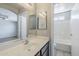 Bathroom features a vanity with double mirrors and a combined shower and bathtub at 16077 W Larkspur Dr, Goodyear, AZ 85338