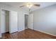 Bedroom with ceiling fan, wood floor, and closet at 16077 W Larkspur Dr, Goodyear, AZ 85338