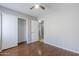 Bedroom with ceiling fan, wood floor, and closet at 16077 W Larkspur Dr, Goodyear, AZ 85338