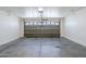 Garage features concrete flooring and a steel sectional door at 16077 W Larkspur Dr, Goodyear, AZ 85338
