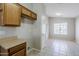 Bright area off kitchen features extra cabinetry and counter space with a view into another room at 16077 W Larkspur Dr, Goodyear, AZ 85338