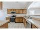 Spacious kitchen with wood cabinets, stainless steel appliances, and ample countertop space at 16077 W Larkspur Dr, Goodyear, AZ 85338