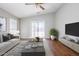 Bright living room featuring a sliding glass door, stylish decor, and hardwood floors at 16077 W Larkspur Dr, Goodyear, AZ 85338