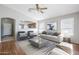 Inviting living room with natural light, a stylish sofa, and modern decor creates a cozy atmosphere at 16077 W Larkspur Dr, Goodyear, AZ 85338