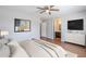 Relaxing main bedroom with en-suite bathroom, a TV, and a comfortable bed at 16077 W Larkspur Dr, Goodyear, AZ 85338