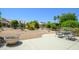 Backyard featuring desert landscaping, patio area, and lush greenery creating a serene outdoor space at 16527 W Blackhawk Ct, Surprise, AZ 85374