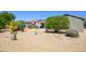Landscaped backyard with desert plants and a covered patio for outdoor enjoyment at 16527 W Blackhawk Ct, Surprise, AZ 85374