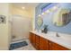 Bathroom features a double sink vanity, tiled floors, and a glass door shower at 16527 W Blackhawk Ct, Surprise, AZ 85374