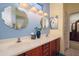 Bathroom showcases a double vanity with white countertops, framed mirrors, and modern lighting at 16527 W Blackhawk Ct, Surprise, AZ 85374