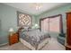 Serene bedroom showcases a comfortable bed, side tables, a ceiling fan, and soft natural light at 16527 W Blackhawk Ct, Surprise, AZ 85374