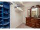 Functional walk-in closet with shelves, hanging space, and a dresser for organization at 16527 W Blackhawk Ct, Surprise, AZ 85374