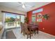 Dining room with a dark table, four ornate chairs, and sliding glass door accessing the patio at 16527 W Blackhawk Ct, Surprise, AZ 85374