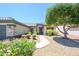 Inviting single-story home featuring a beautiful stone facade and mature landscaping at 16527 W Blackhawk Ct, Surprise, AZ 85374