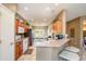 Open concept kitchen with a breakfast bar, plenty of counter space, and access to the dining area at 16527 W Blackhawk Ct, Surprise, AZ 85374