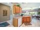Bright kitchen features a light countertop and updated appliances, seamlessly blending into the adjacent dining area at 16527 W Blackhawk Ct, Surprise, AZ 85374
