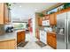 Well-equipped kitchen featuring wood cabinets, stainless steel appliances, and tile flooring at 16527 W Blackhawk Ct, Surprise, AZ 85374