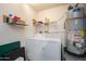 Practical laundry room equipped with a washer, dryer, and water heater at 16527 W Blackhawk Ct, Surprise, AZ 85374
