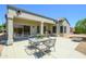 Charming outdoor patio setup with a table and chairs, perfect for al fresco dining and relaxation at 16527 W Blackhawk Ct, Surprise, AZ 85374