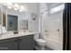 A well-lit bathroom features a vanity with modern fixtures, a toilet, and a shower-tub combo with tiled walls at 16536 W Rock Springs Ln, Surprise, AZ 85374