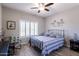 Bedroom with shutters, ceiling fan, and wood-look flooring at 16536 W Rock Springs Ln, Surprise, AZ 85374