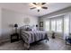 Calming main bedroom features stylish wood-look floors, fan, and natural light at 16536 W Rock Springs Ln, Surprise, AZ 85374