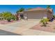 Charming single-story home with a well-manicured lawn and a two-car garage at 16536 W Rock Springs Ln, Surprise, AZ 85374