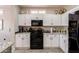 Beautiful kitchen with white cabinets, granite counters, and stainless steel appliances at 16536 W Rock Springs Ln, Surprise, AZ 85374