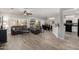 Open-concept living room with hardwood floors and a seamless connection to dining area at 16536 W Rock Springs Ln, Surprise, AZ 85374