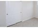Neutral bedroom with tile flooring, closet, and an electrical outlet, offering a simple design at 17419 W Via De Luna Dr, Surprise, AZ 85387