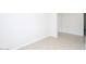 Empty bedroom with light-colored tile floors, an electrical outlet, and a blank canvas at 17419 W Via De Luna Dr, Surprise, AZ 85387