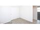 A bedroom with neutral carpet, a closet, and a door to the rest of the home at 17419 W Via De Luna Dr, Surprise, AZ 85387