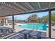 A beautifully maintained community pool area with seating and shaded pergola structure at 17419 W Via De Luna Dr, Surprise, AZ 85387