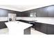 Modern kitchen featuring dark cabinets, a kitchen island, white subway tile backsplash, and stainless appliances at 17419 W Via De Luna Dr, Surprise, AZ 85387