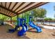 Fun community playground with covered play area and adjacent pool visible in background at 17419 W Via De Luna Dr, Surprise, AZ 85387