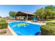 Community playground featuring a covered play area and vibrant sun-themed splash pad at 17419 W Via De Luna Dr, Surprise, AZ 85387