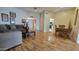 Spacious living room featuring hardwood floors, comfortable seating, and an open layout leading to the kitchen at 17463 N Del Webb Blvd, Sun City, AZ 85373