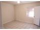 Minimalist bedroom with tile floors and a window, offering a blank canvas for personalization at 1914 W Colter St, Phoenix, AZ 85015