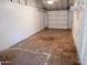 Bright garage with terracotta tile flooring and white walls offers functionality and lots of potential at 1914 W Colter St, Phoenix, AZ 85015