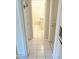 Bright hallway with tile flooring, leading to the bathroom and other areas of the home at 1914 W Colter St, Phoenix, AZ 85015